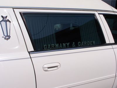 White hearse with Garmany & Carden lettered on the side window