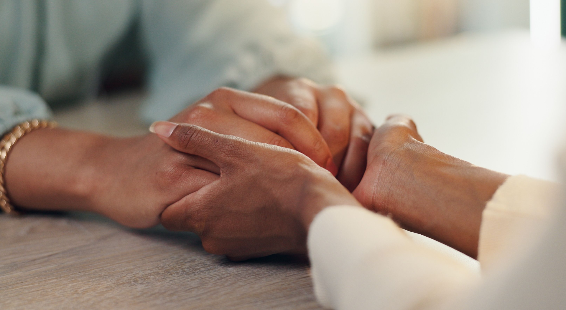 A close up of a person holding another person 's hand.