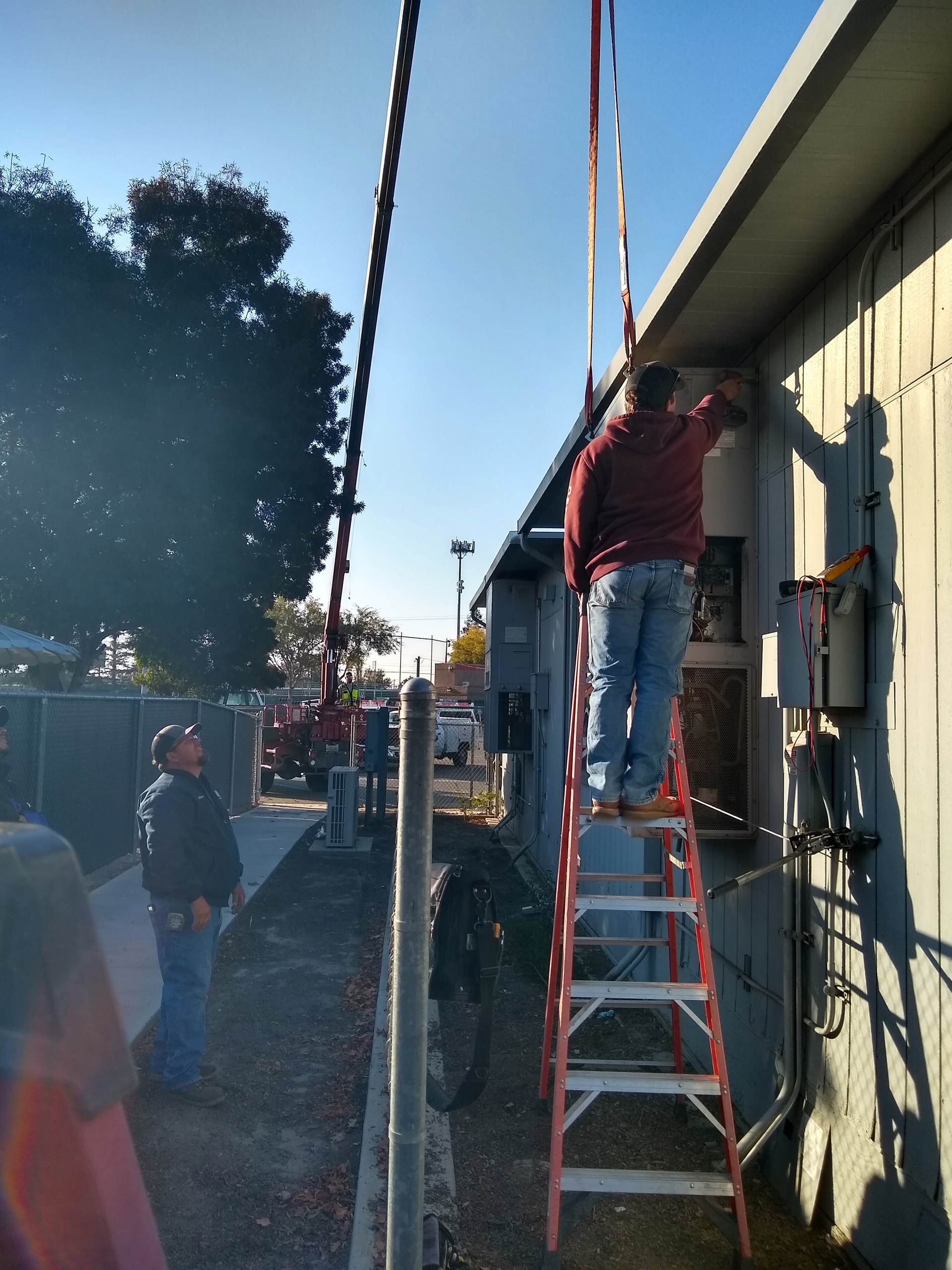 a man is working on an air conditioner outside of a building .