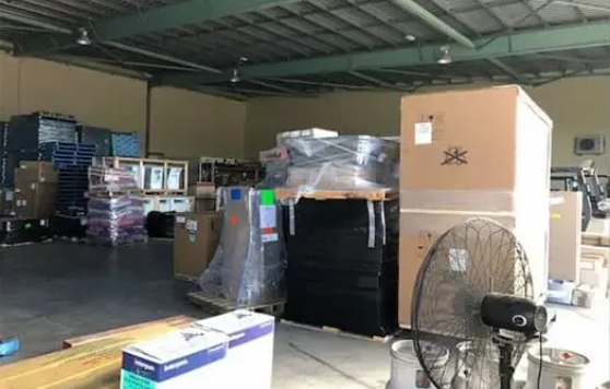 Warehouse Interior With Stacked Boxes — Griffin Distributors In Mount St John, QLD