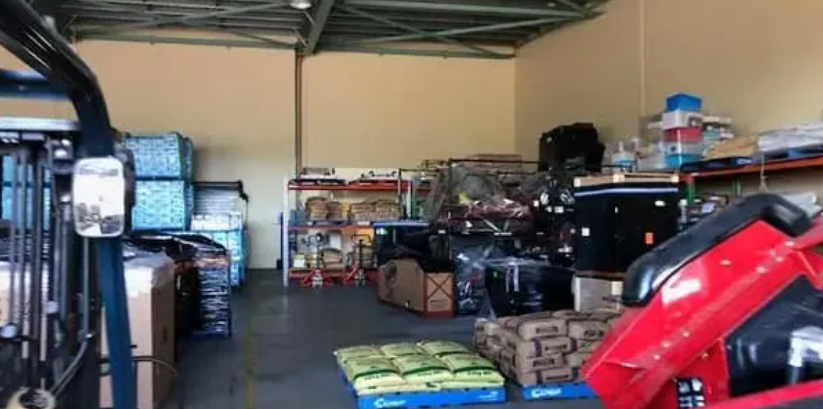 Warehouse Aisle With Stacked Pallets of Packaged Goods — Griffin Distributors In Mount St John, QLD