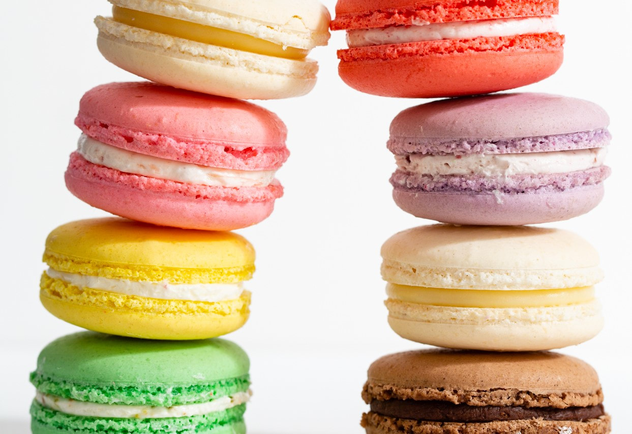 Stacked colorful macarons on a white background