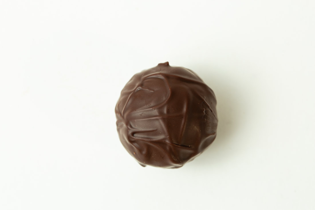Chocolate truffle candy on a white background