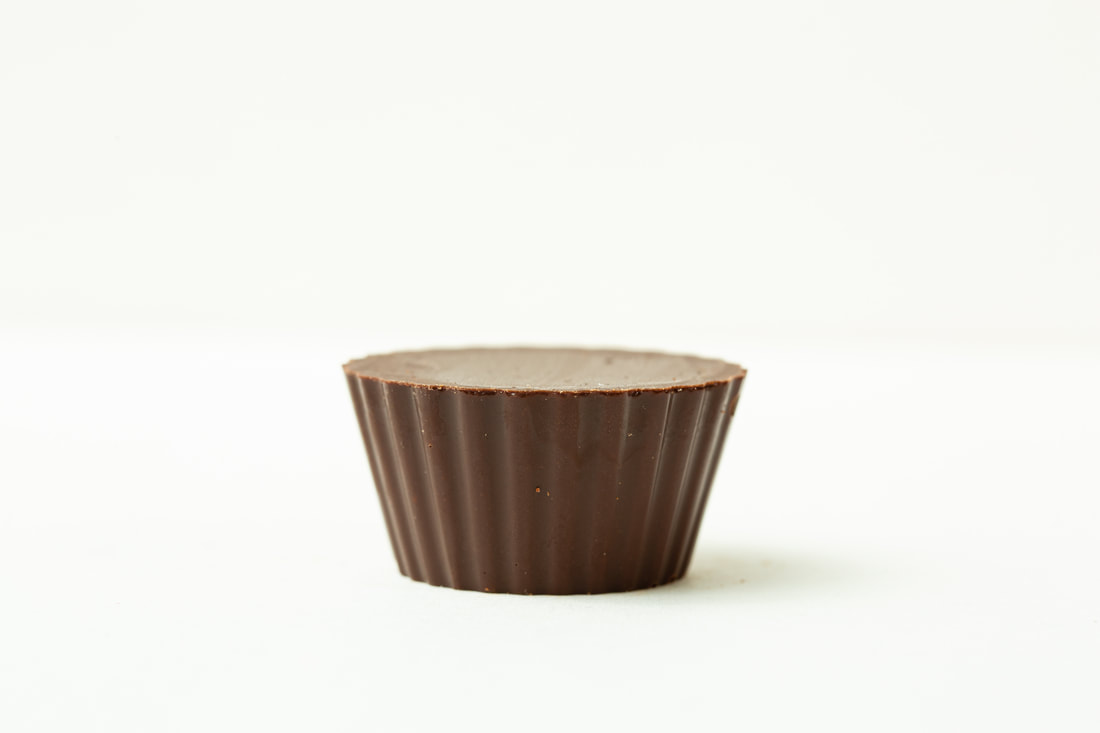 Small brown fluted baking cup on a white background