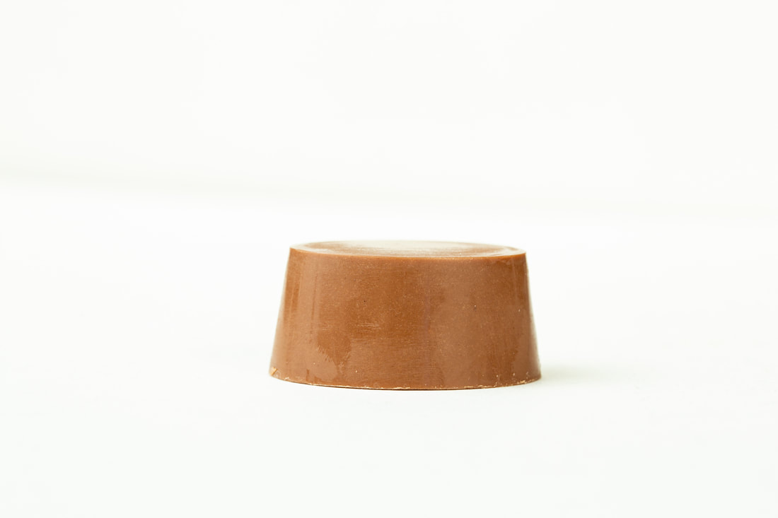 Small brown cylindrical stool or pedestal on a white background