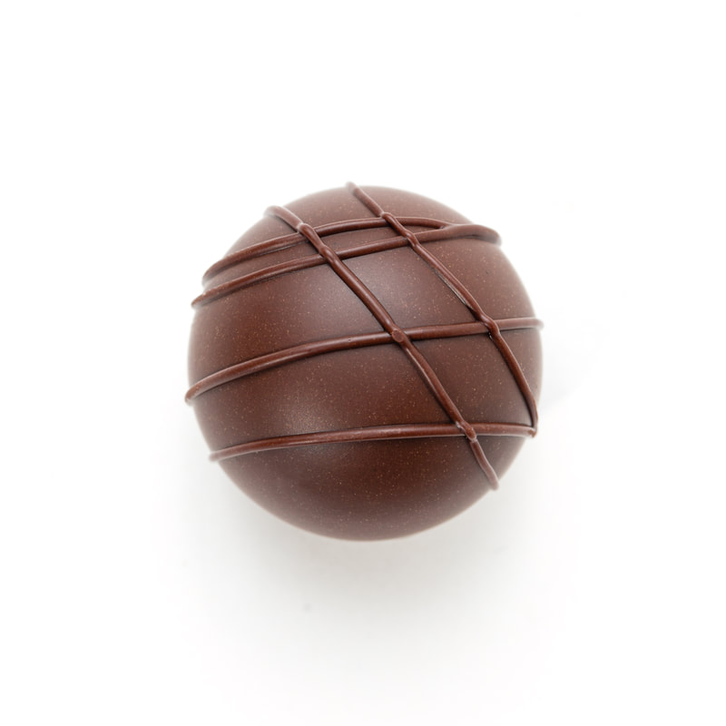Chocolate truffle with diagonal drizzle on a white background