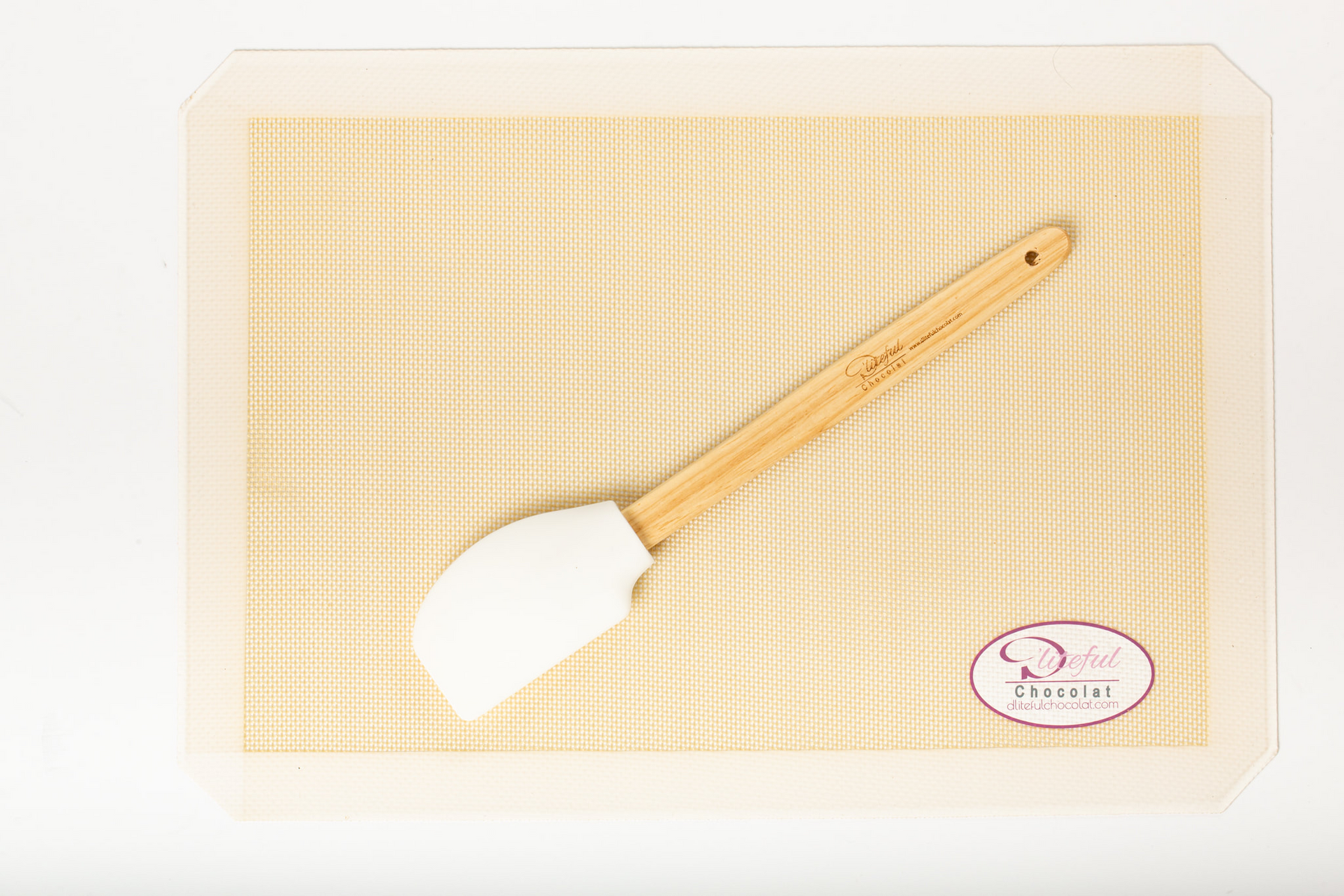 White spatula with a wooden handle on a beige woven mat