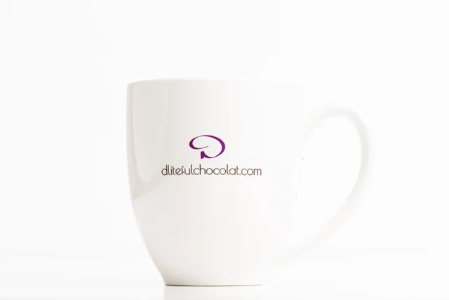 White mug with the text “The answer is Chocolate. Wait…what was the question?” and a pink flourish.