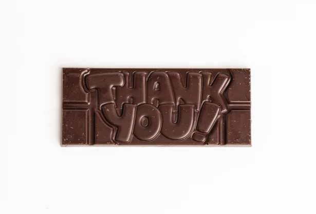 Chocolate bar with raised “THANK YOU” lettering on a white background