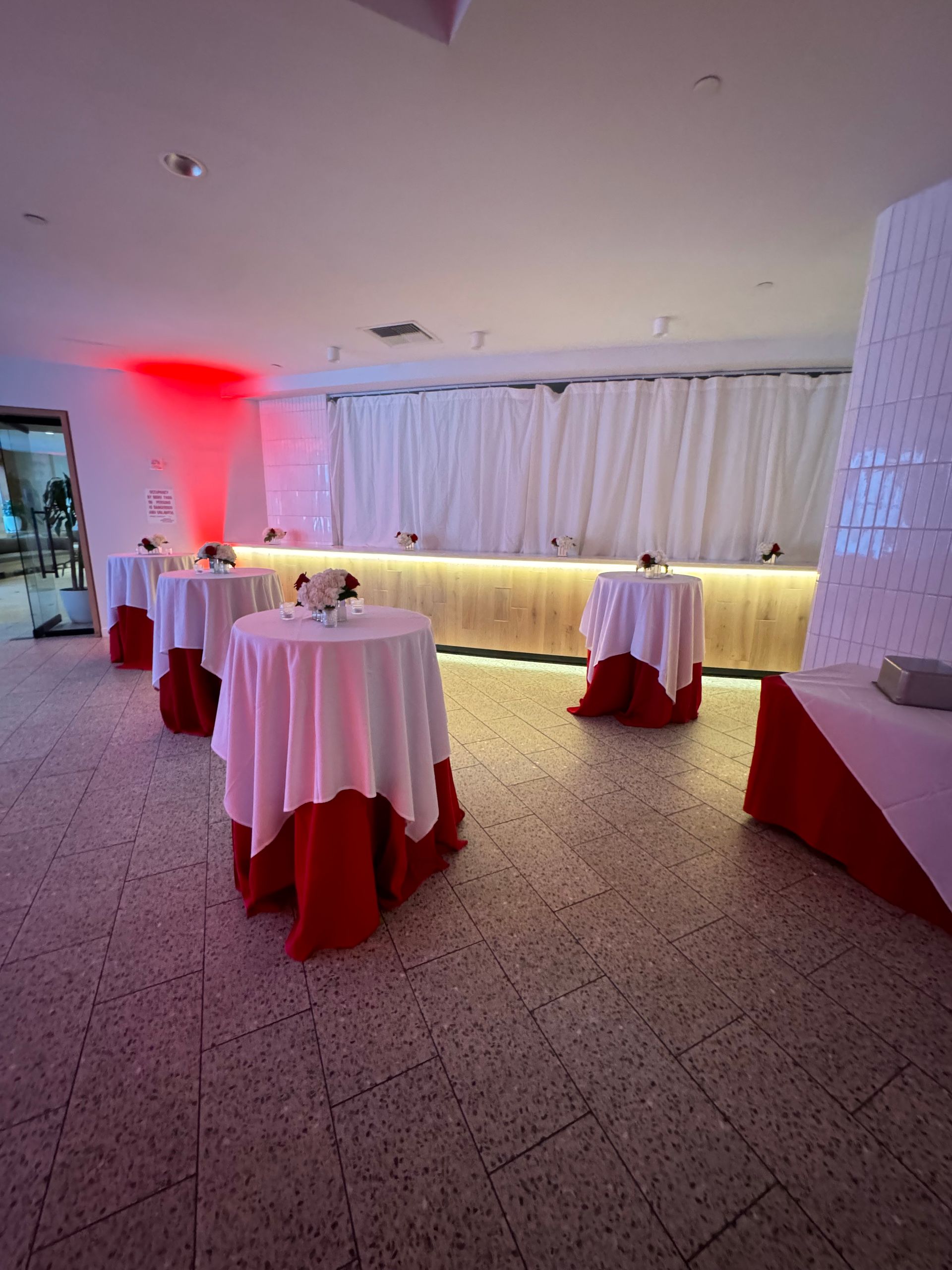 A room filled with tables and a bar.