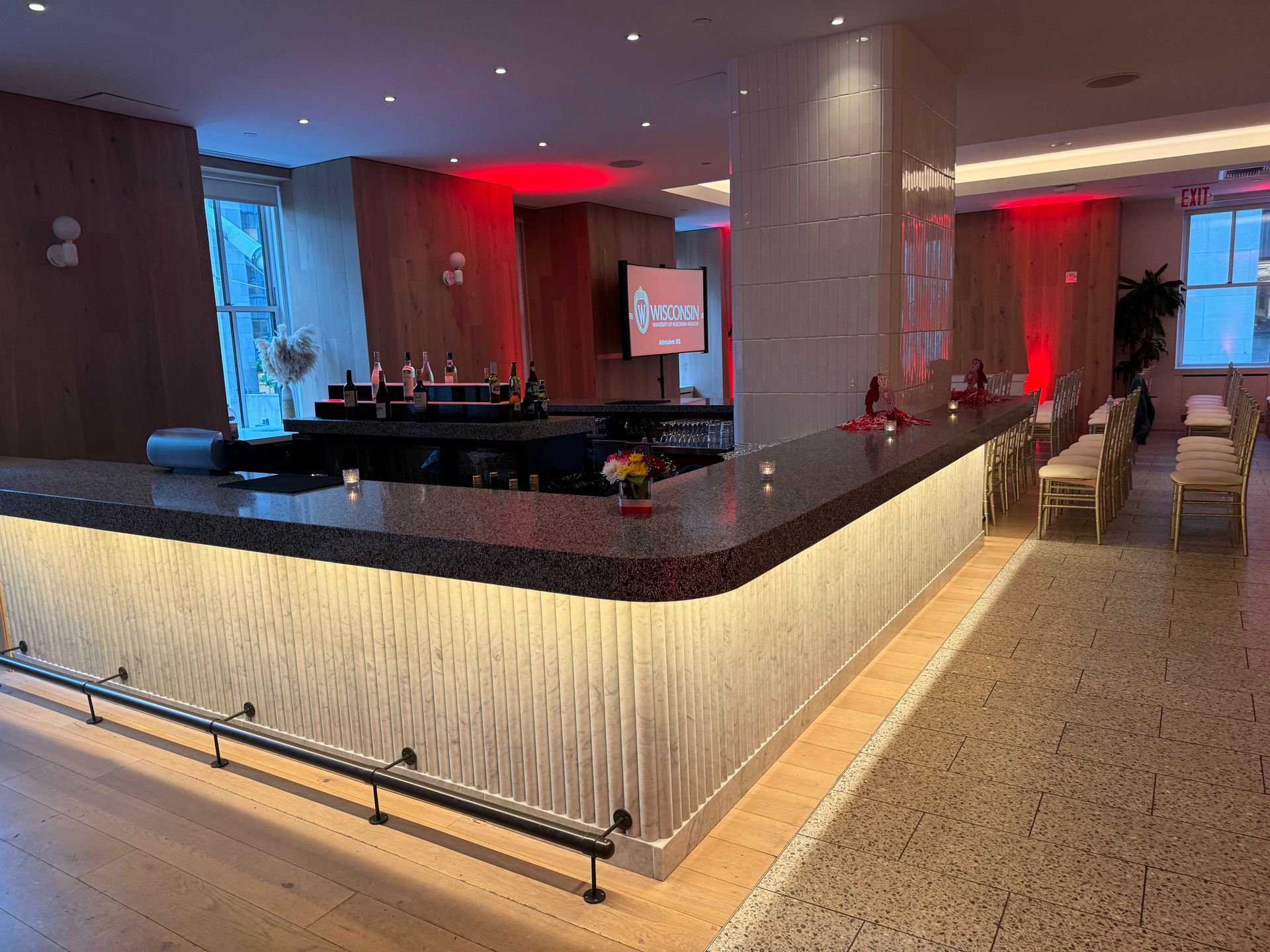 There is a long bar in the middle of the room.