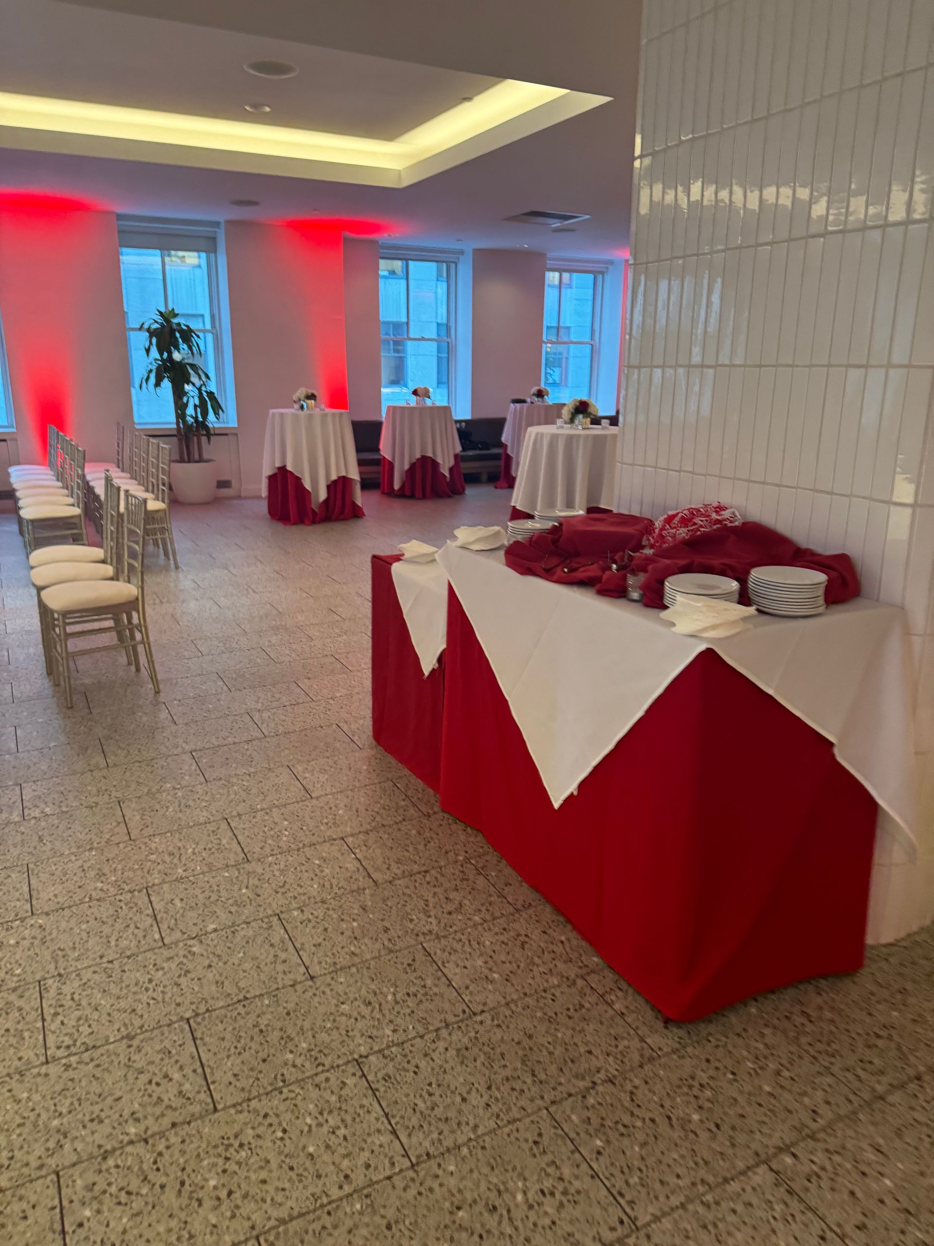 A large room with red and white tables and chairs