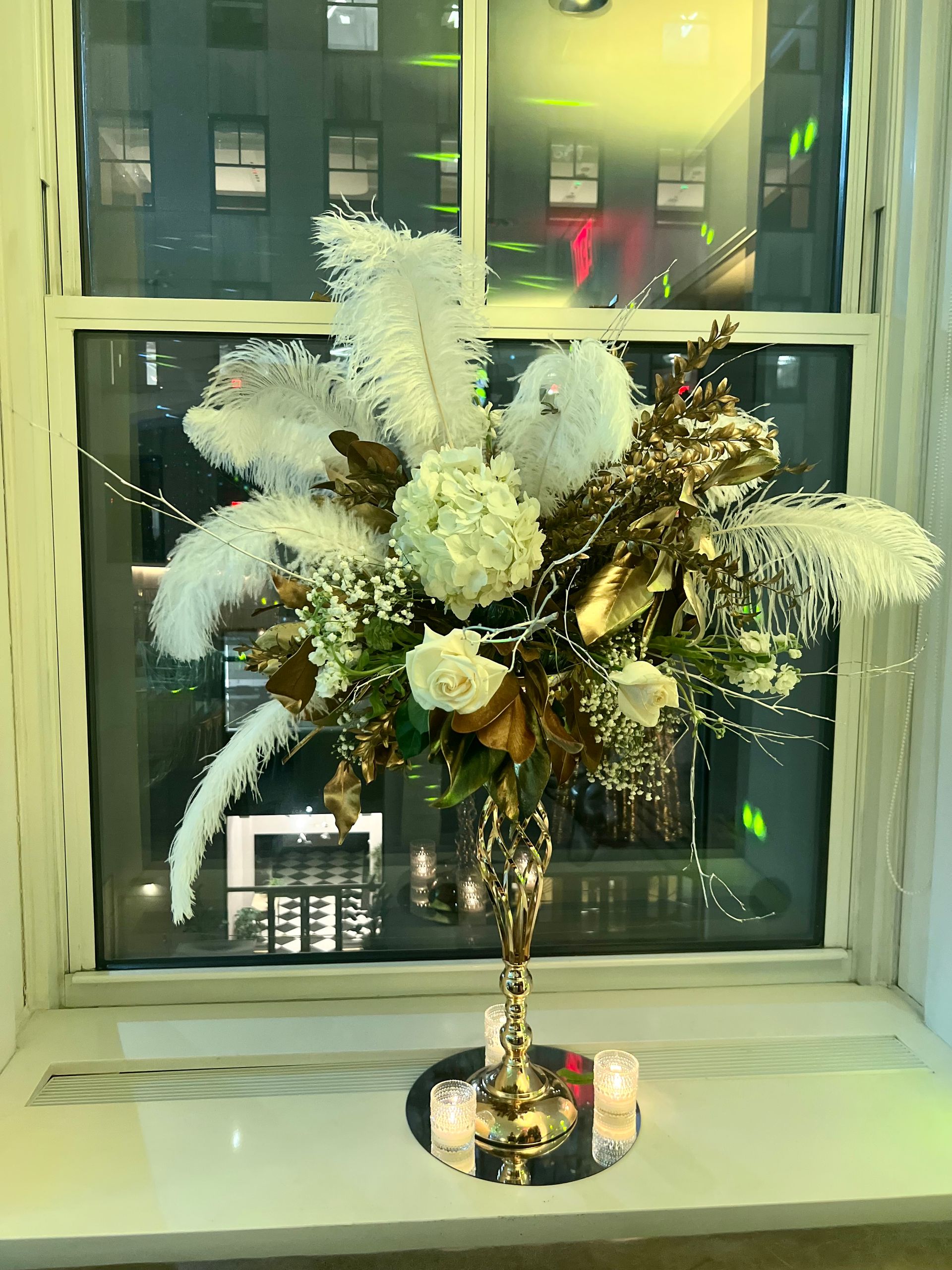 EQX City Catering Event Space at Rockefeller Center - A vase filled with flowers is sitting on a window sill.