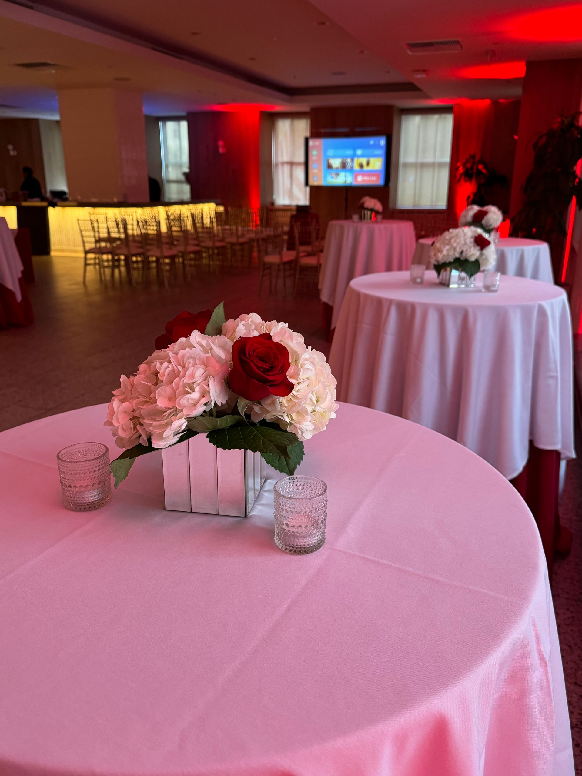 A table with a vase of flowers on it in a room.
