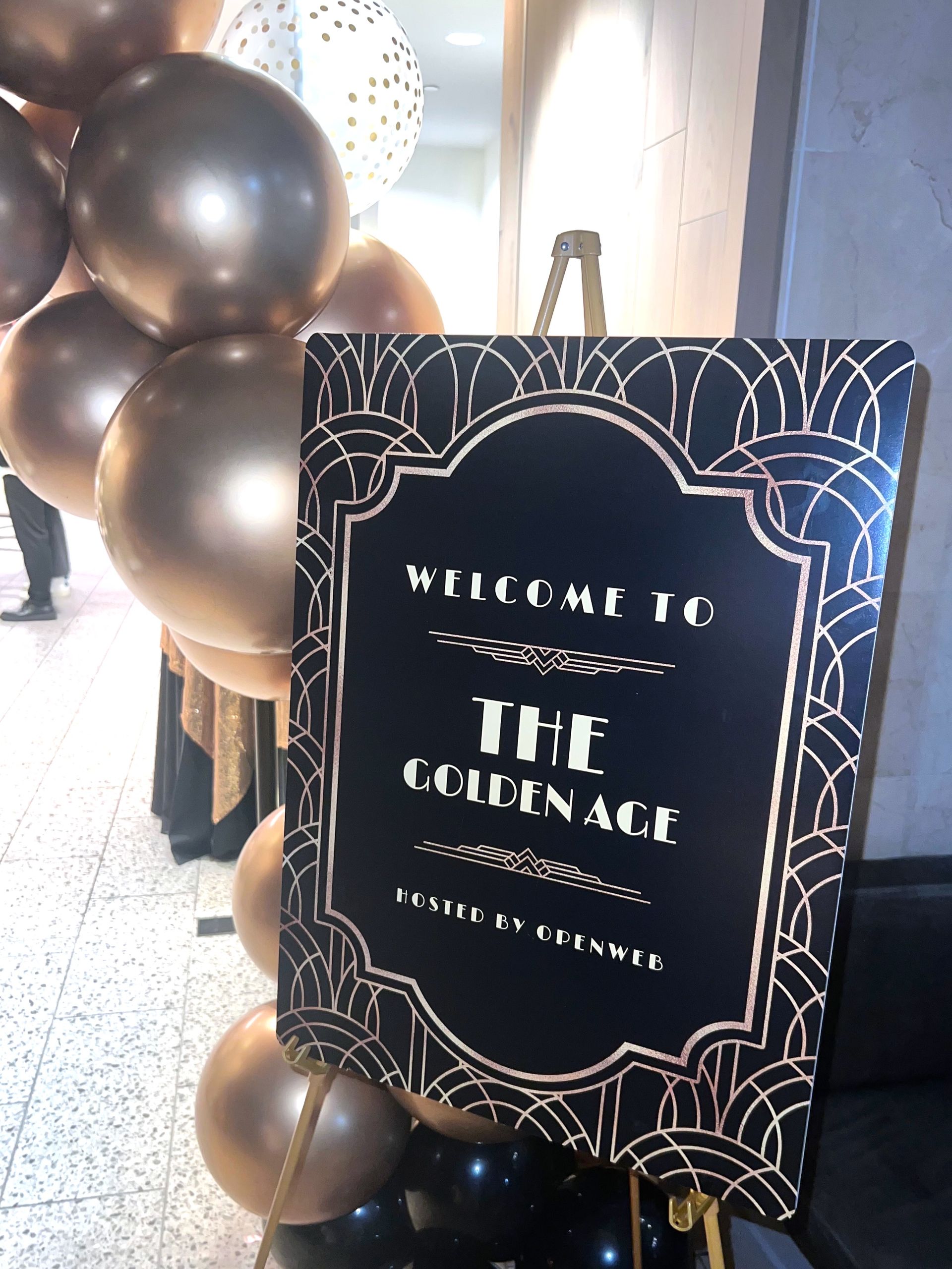 EQX City Catering Event Space at Rockefeller Center - A sign that says welcome to the golden age is surrounded by balloons.