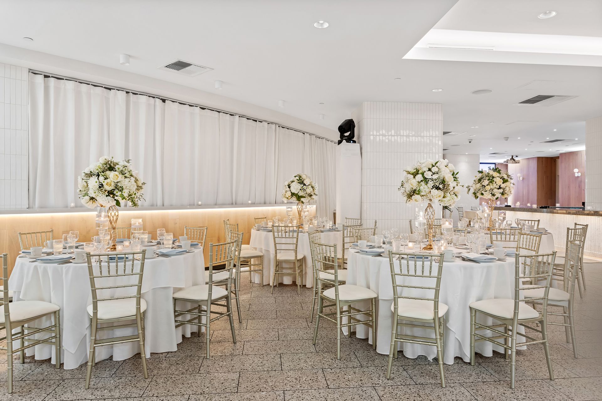 EQX City Catering Event Space at Rockefeller Center - A large room with tables and chairs set up for a wedding reception