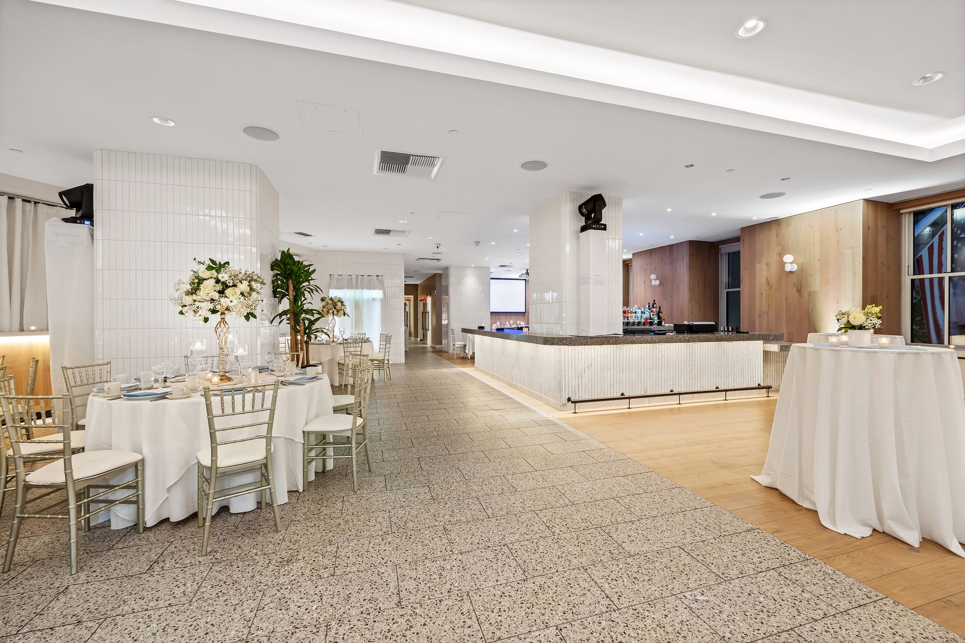 EQX City Catering at Rockefeller Center. A large room with tables and chairs set up for a wedding reception.