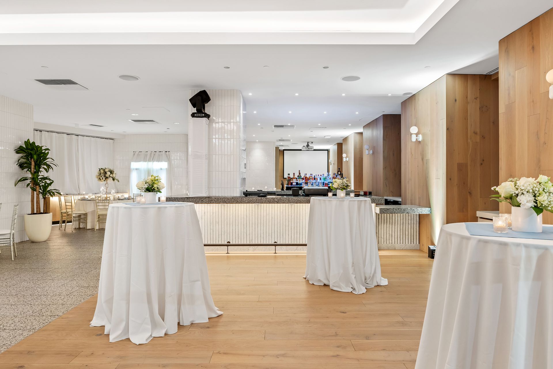 EQX City Catering at Rockefeller Center. A room with tables and a bar in it.