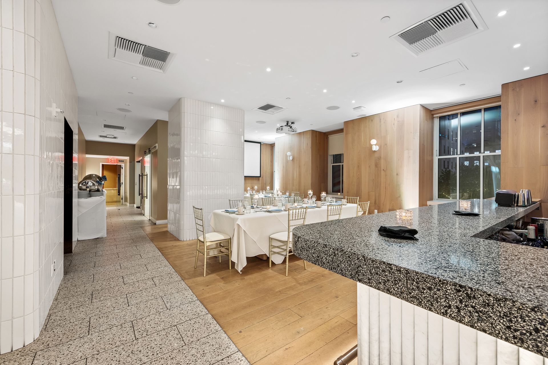 EQX City Catering at Rockefeller Center. A large room with tables and chairs in it