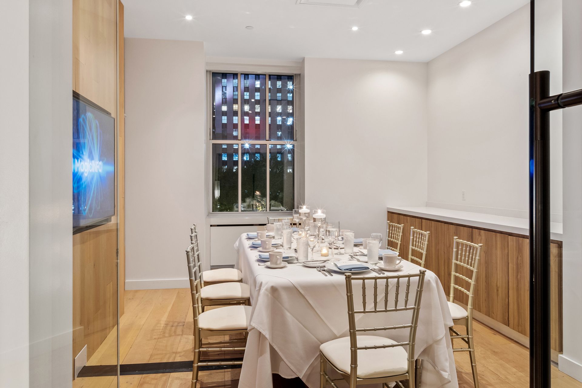 There is a long table and chairs in the room.