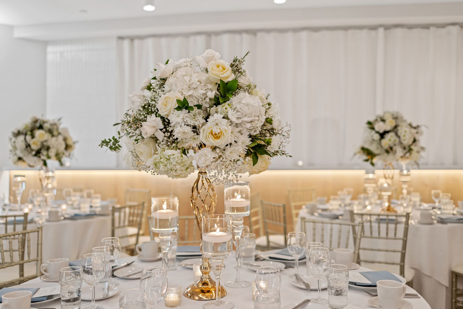 EQX City Catering at Rockefeller Center. A table set for a wedding reception with flowers and candles on it.