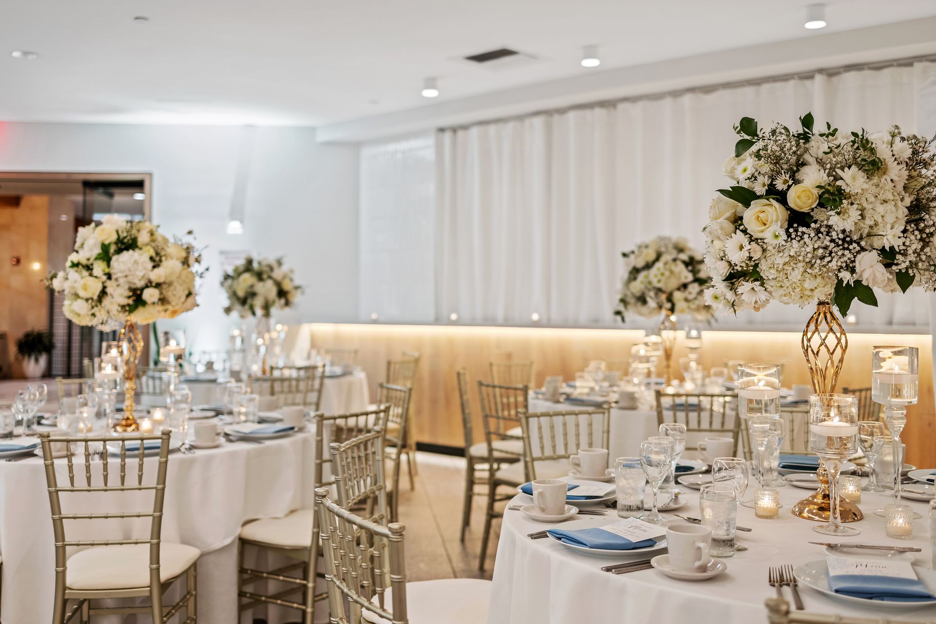 EQX City Catering at Rockefeller Center. A room with tables and chairs set up for a wedding reception.