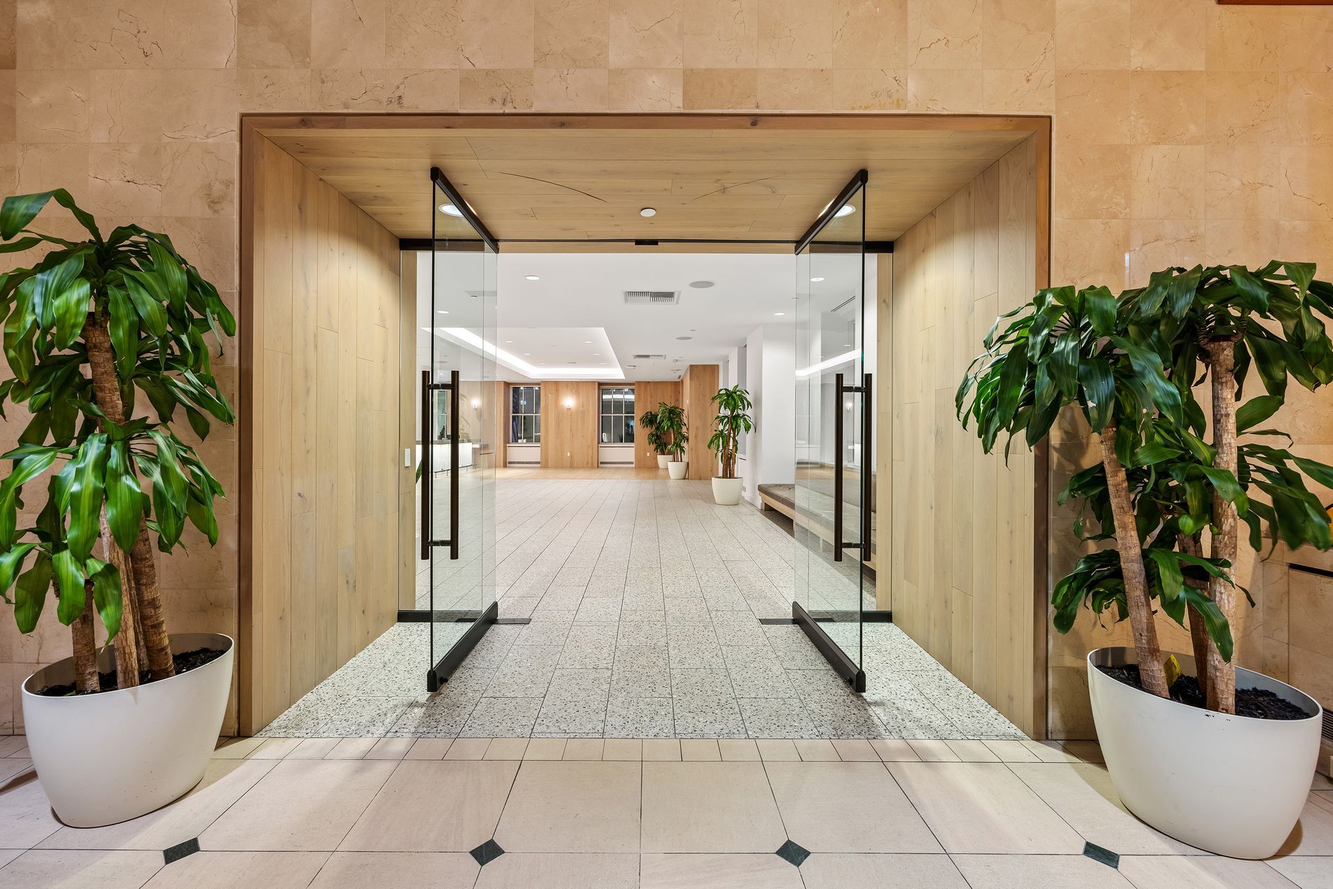 EQX City Catering Event Space at Rockefeller Center - A hallway with two potted plants and a glass door