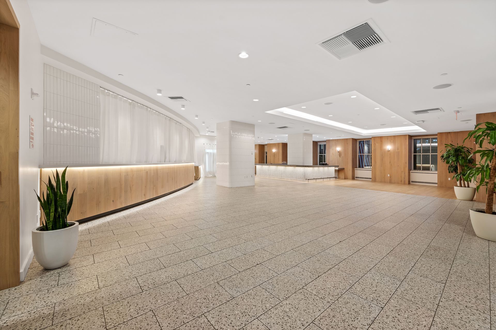 EQX City Catering Event Space at Rockefeller Center - A large lobby with a check in desk and a terrazzo floor.