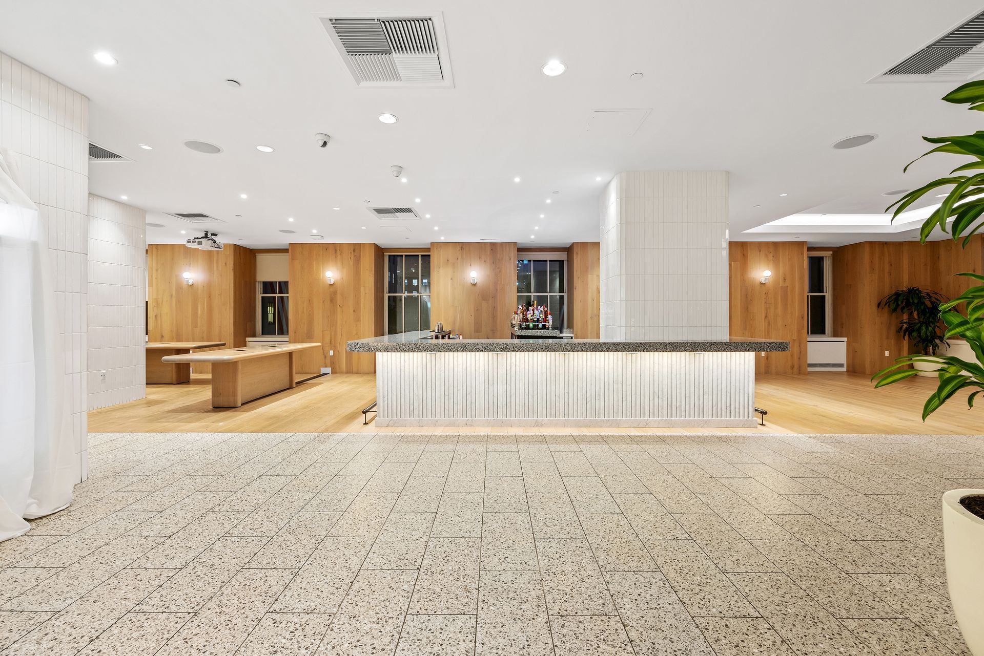 EQX City Catering Event Space at Rockefeller Center - A large room with a counter in the middle of it.