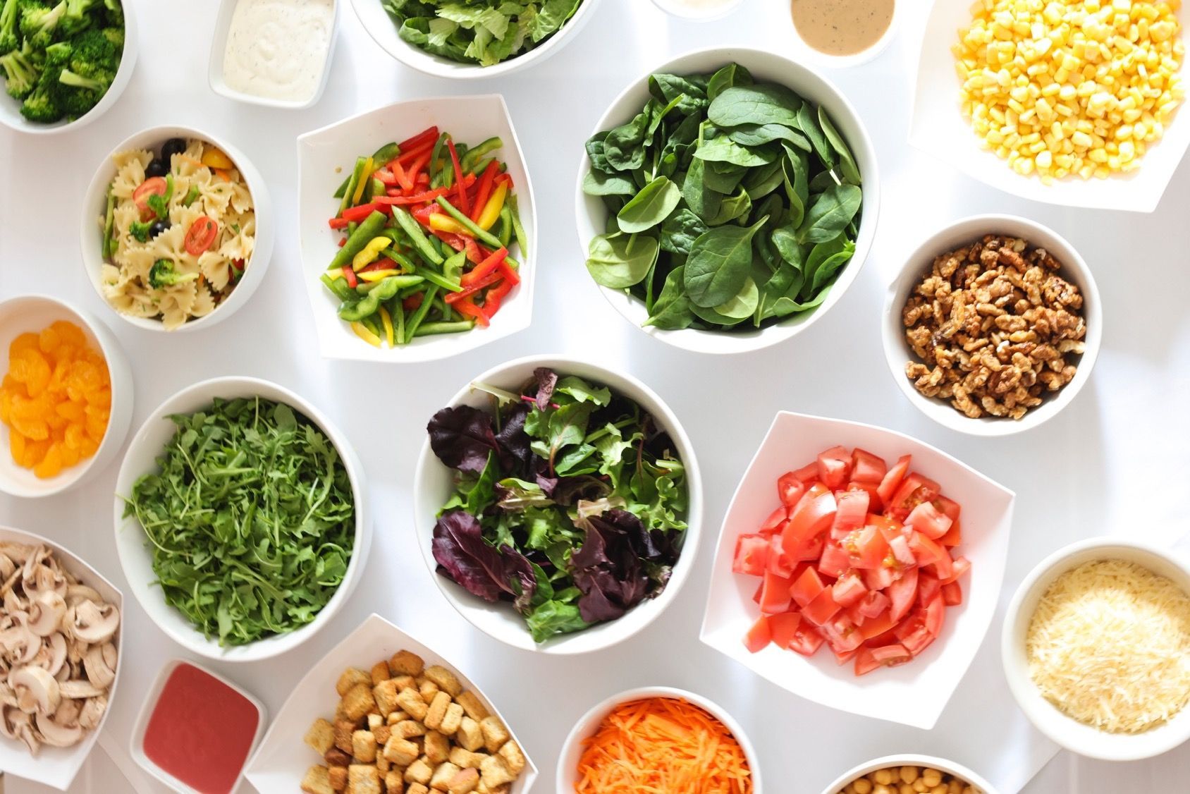 A table topped with bowls of different types of vegetables. EQX Events & City Catering