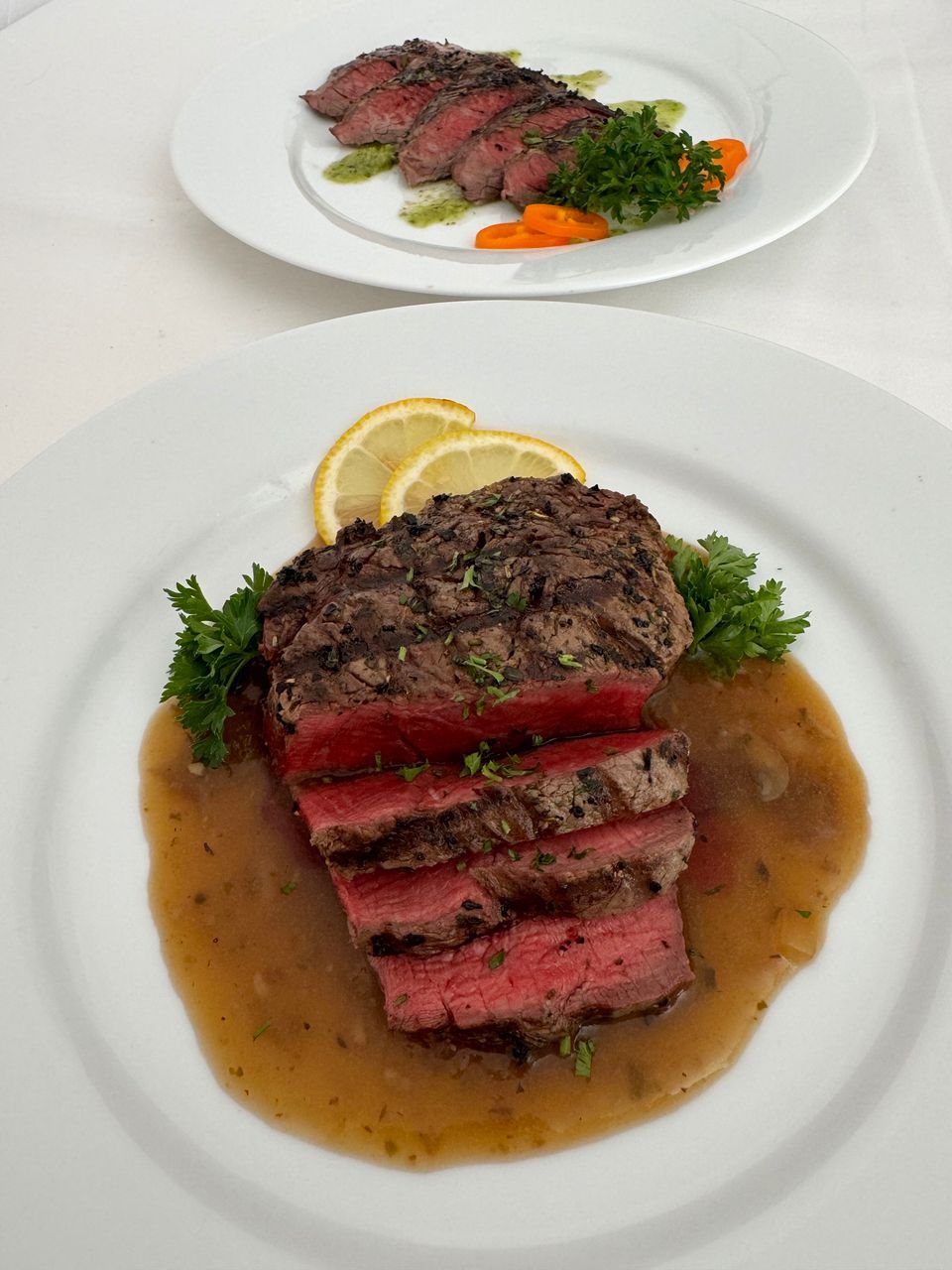 EQX City Catering Event Space at Rockefeller Center - A table set for a wedding reception with plates of food and a vase of flowers.