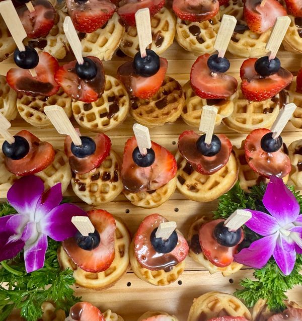 EQX City Catering Event Space at Rockefeller Center - There are many different types of cookies and fruit on the plate.