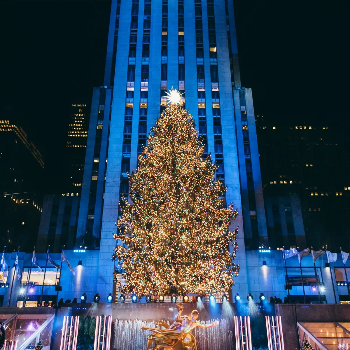 EQX City Catering Event Space at Rockefeller Center - A large christmas tree is lit up in front of a building
