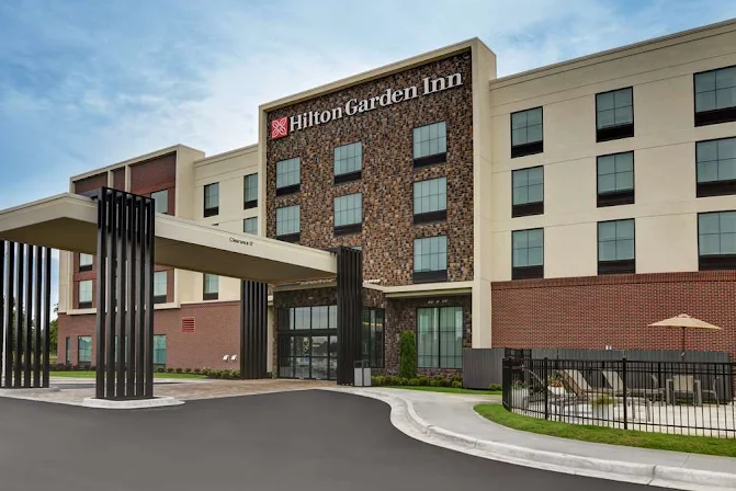 Hilton Garden Inn hotel entrance with covered drop-off drive and brick facade