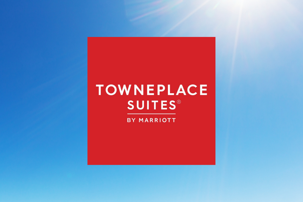 TownePlace Suites by Marriott logo on a red square over a blue sky background