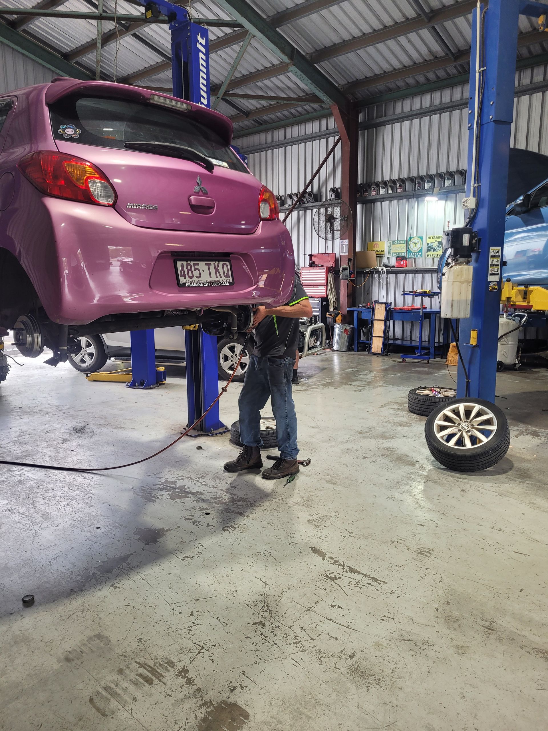 Pink Hatchback on a Lift in an Auto Repair Shop — Fischer Automotive in Svensson Heights, QLD