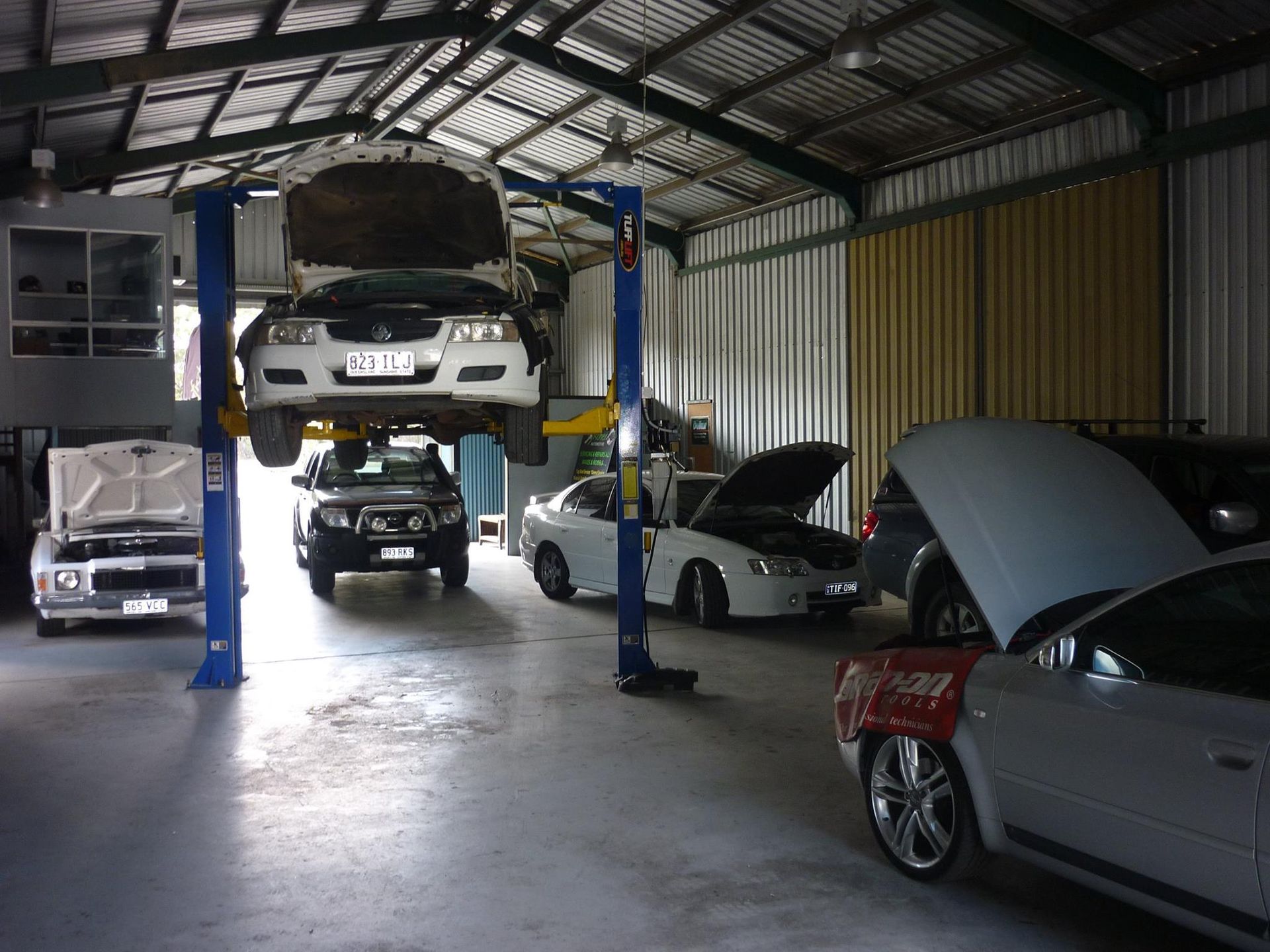 Auto Repair Shop With Several Cars on Lifts — Fischer Automotive in Svensson Heights, QLD