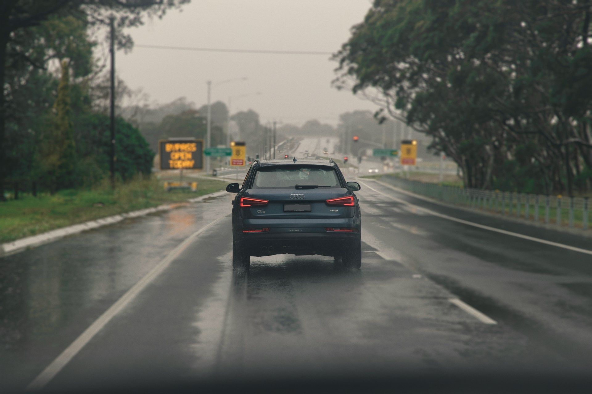 Black SUV Driving on a Wet Road in Rainy Traffic — Fischer Automotive in Svensson Heights, QLD