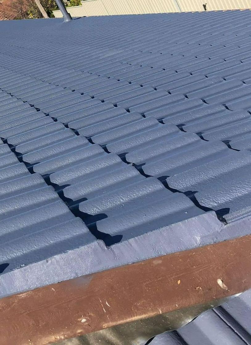 A Close Up of a Blue Roof With a Shadow on It — RJT Roofing In Bonner, ACT