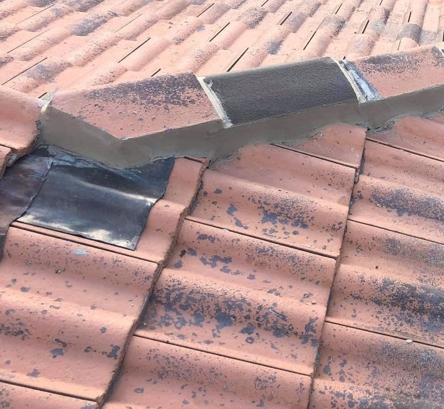 A Close Up of a Tiled Roof With a Roof Drain — RJT Roofing In Bonner, ACT