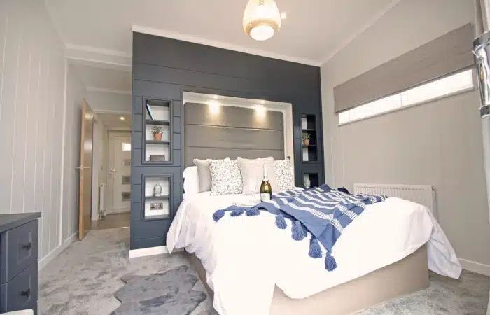 A bedroom with a large bed and a dresser.