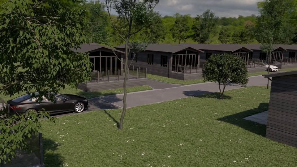 A car is parked in front of a row of houses.
