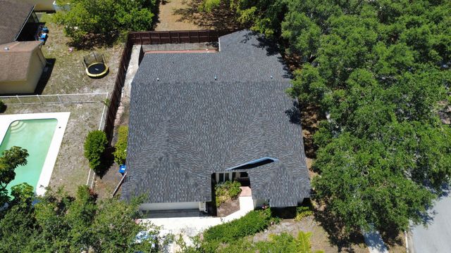 A man is working on a kitchen in a house under construction