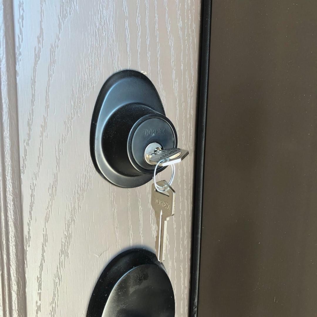 A close up of a door lock with a key in it
