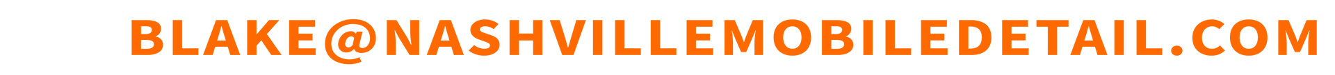 A blurred image of a row of orange sticks on a white background.