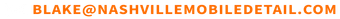 A blurred image of a row of orange sticks on a white background.