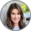 A woman with long brown hair is smiling in a circle.