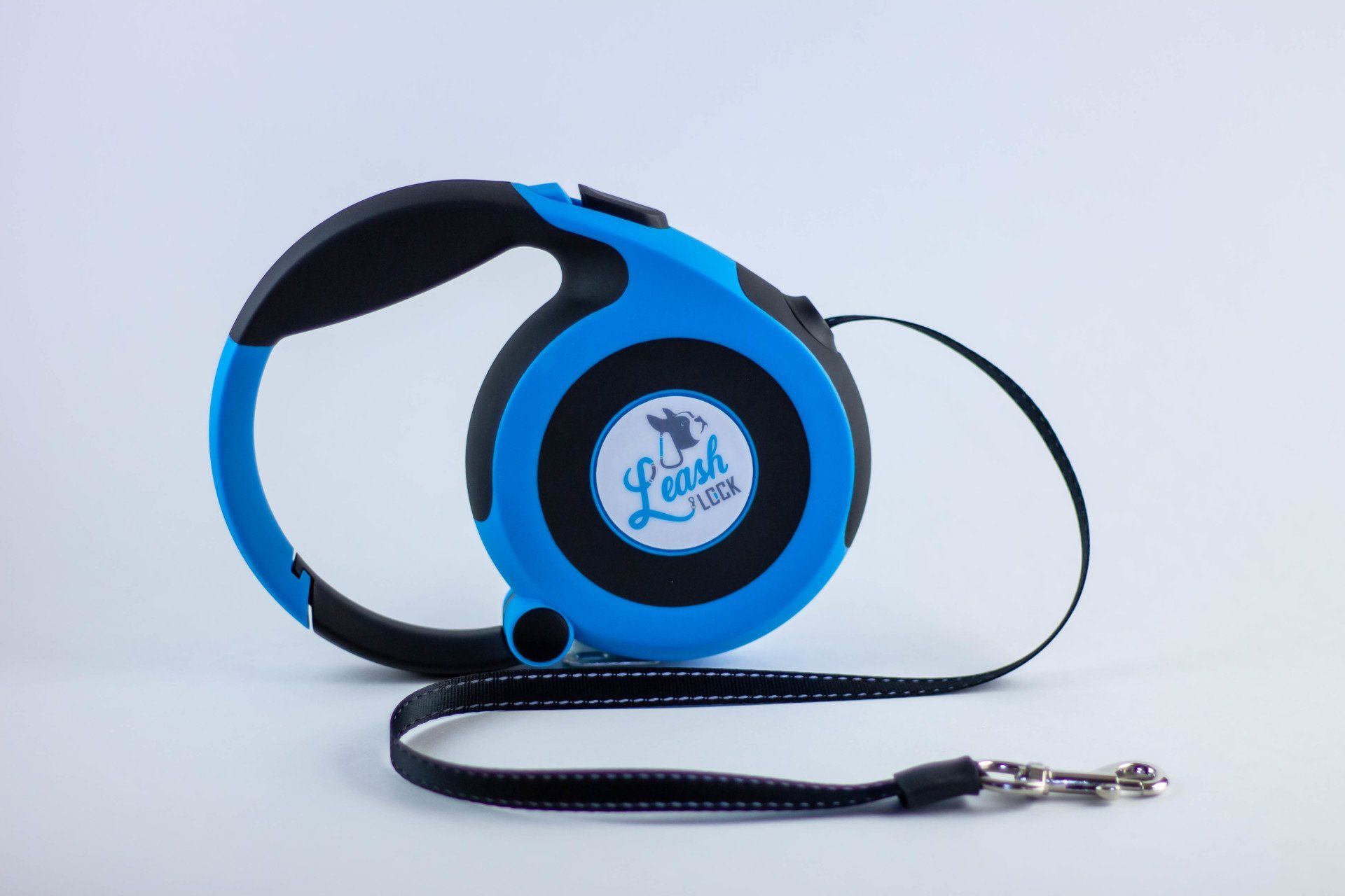 Blue and black retractable dog leash with reflective tape and logo.