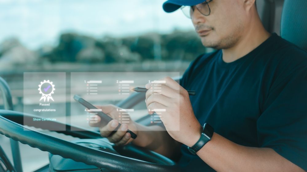 Man using a tablet in a car, with transparent digital interface icons overlaid on the windshield.
