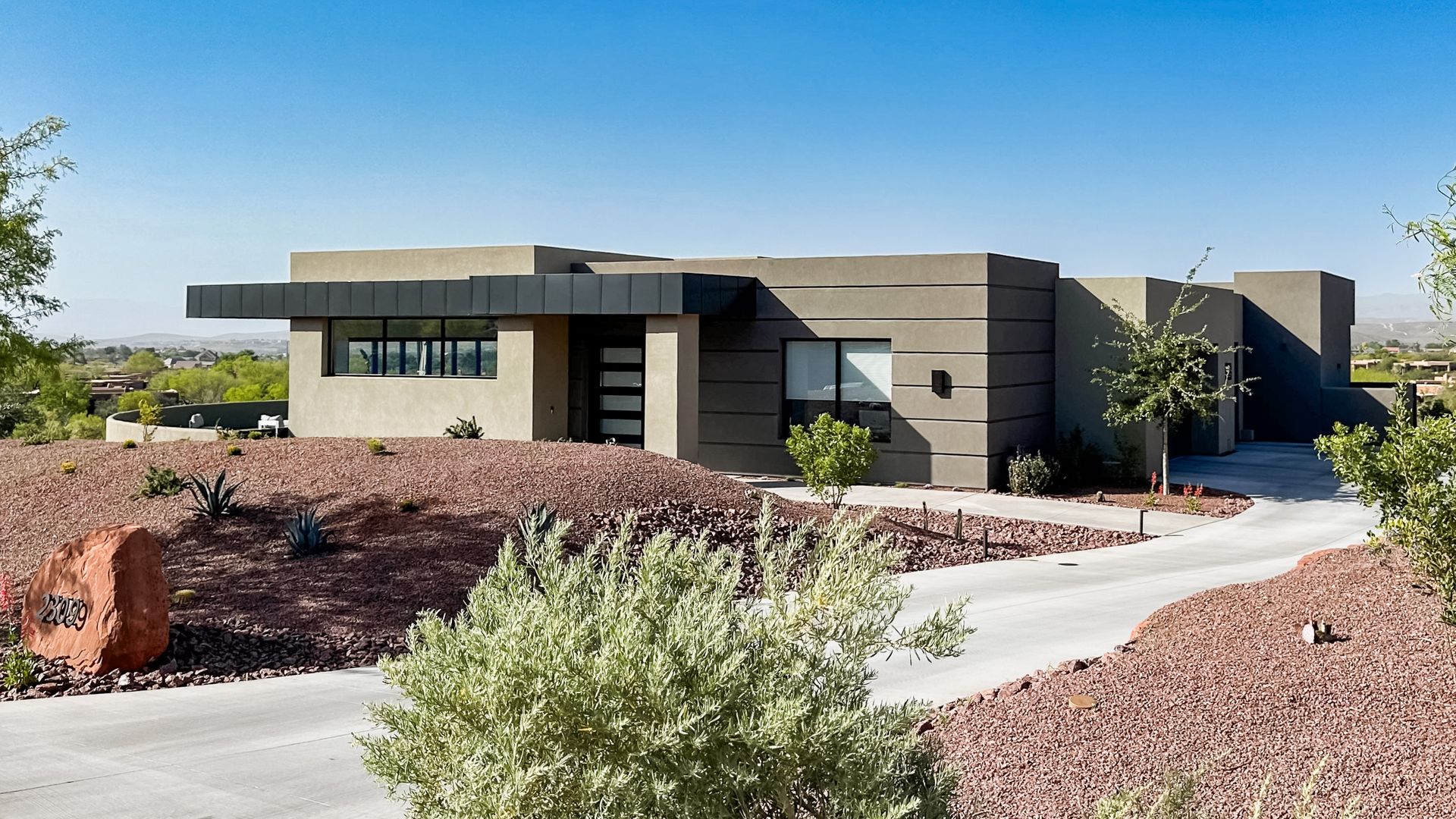 a large house is sitting on top of a hill in the desert .